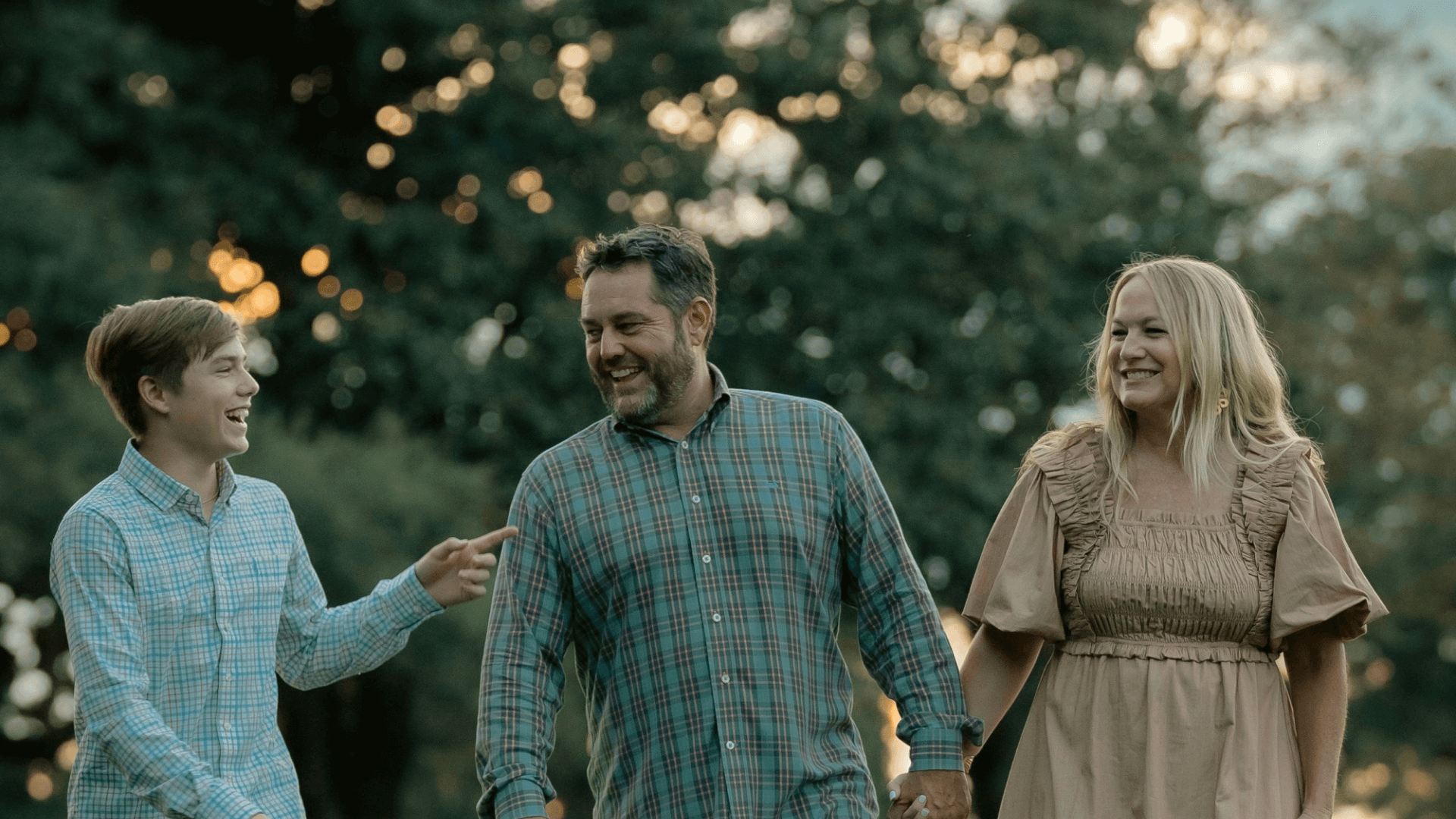 A photo of a couple with their son laughing