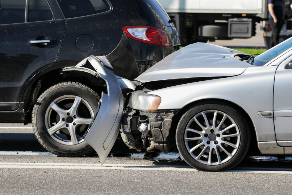 Rear-end collision involving a silver car and a black SUV, illustrating vehicle damage.