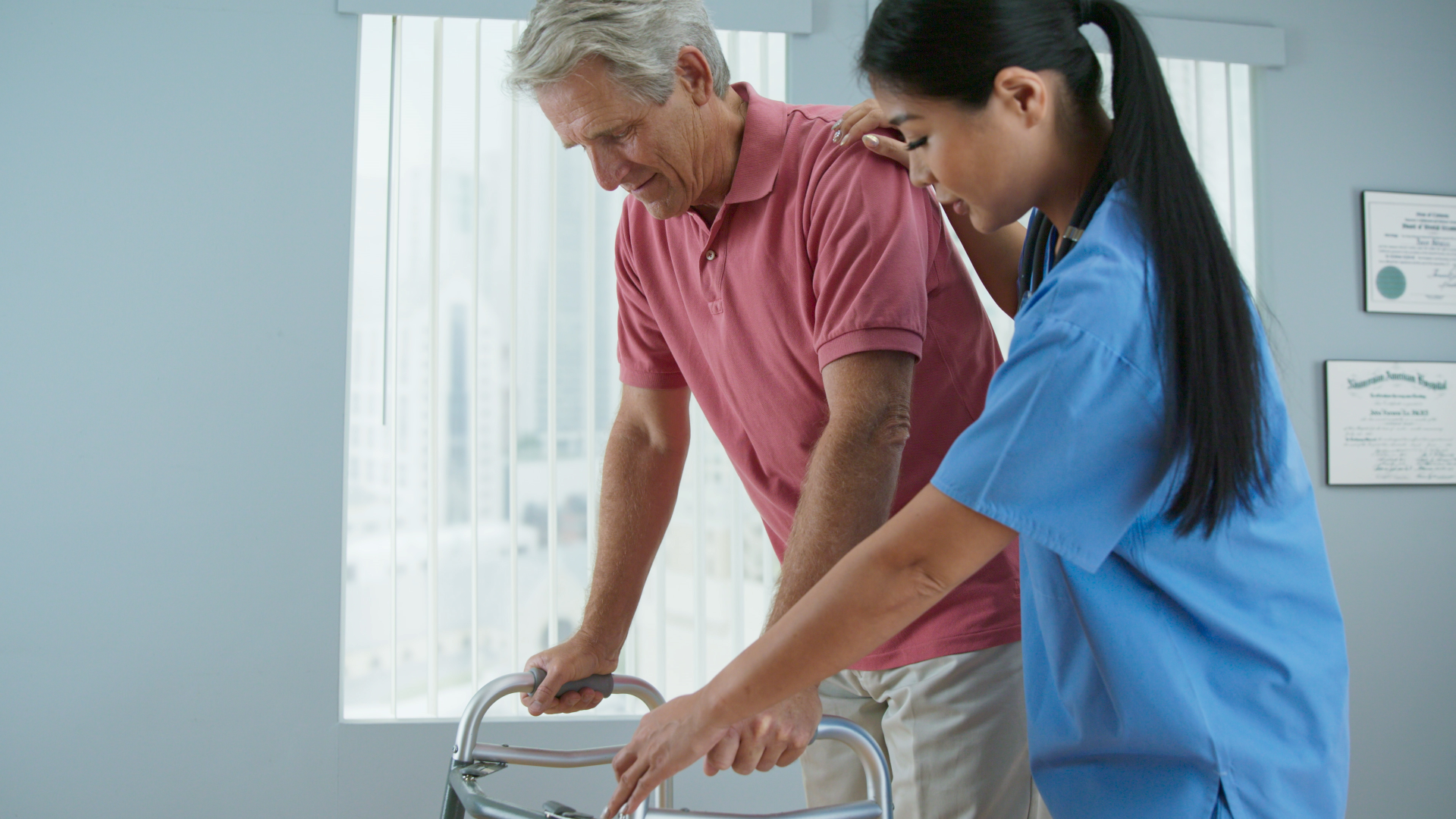 A healthcare worker assisting an elderly man with a walker during rehabilitation in a medical setting.