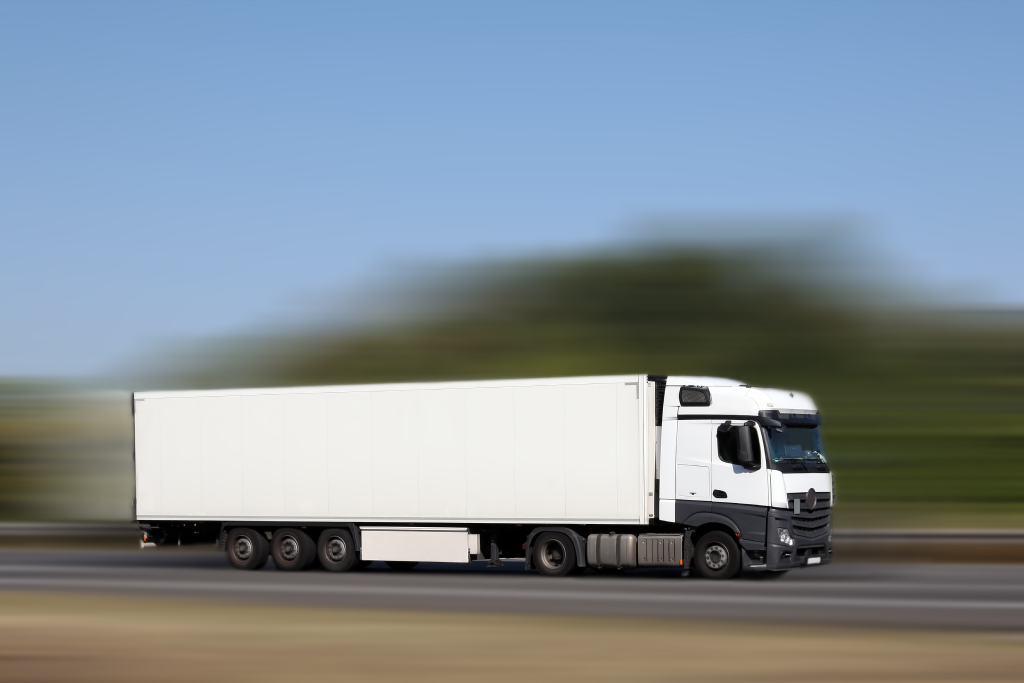 a semi-truck speeding down a highway