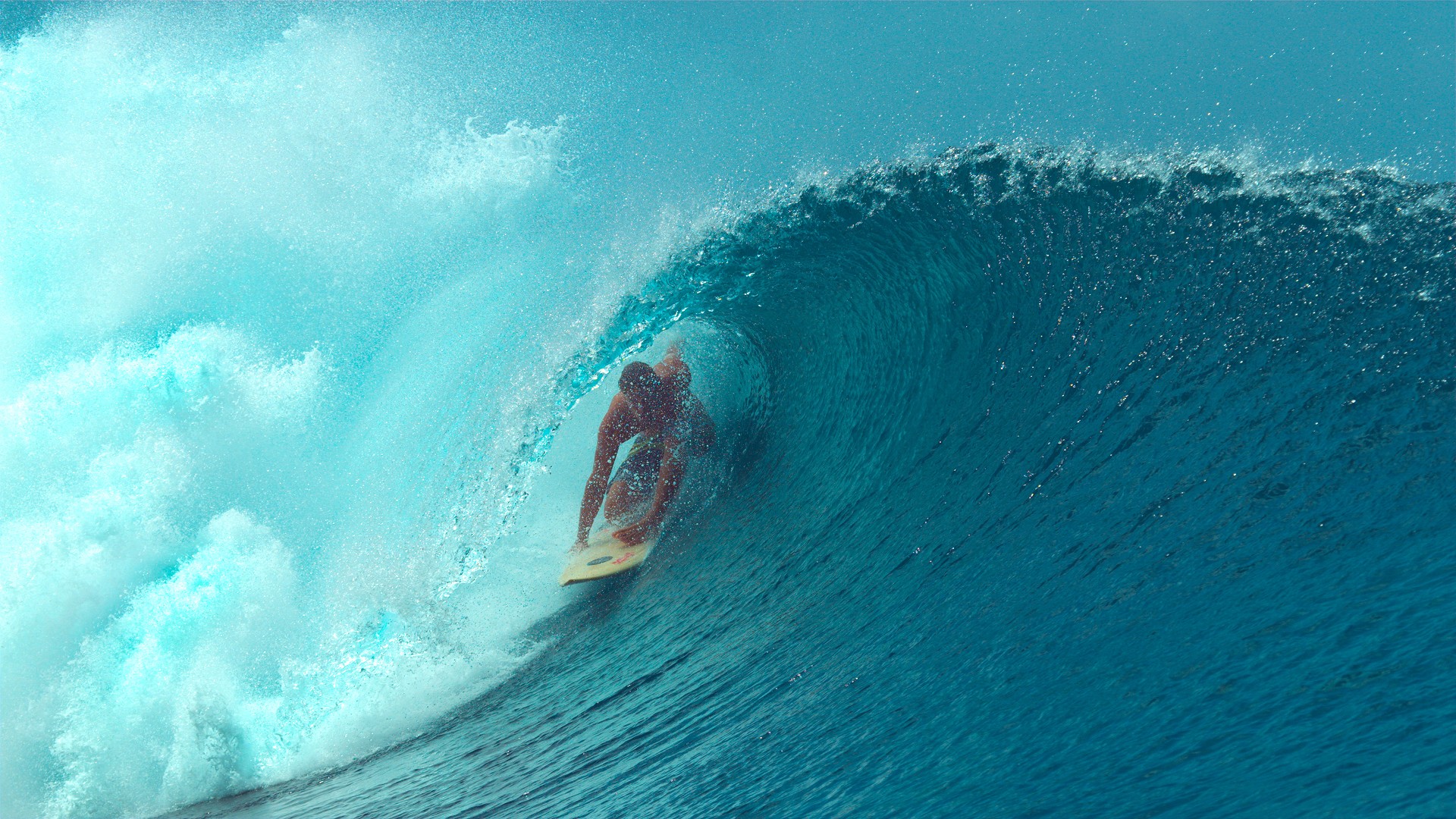 Surfer riding inside a large ocean wave