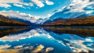 Snow-capped mountains reflected in a still lake near Bozeman, Montana