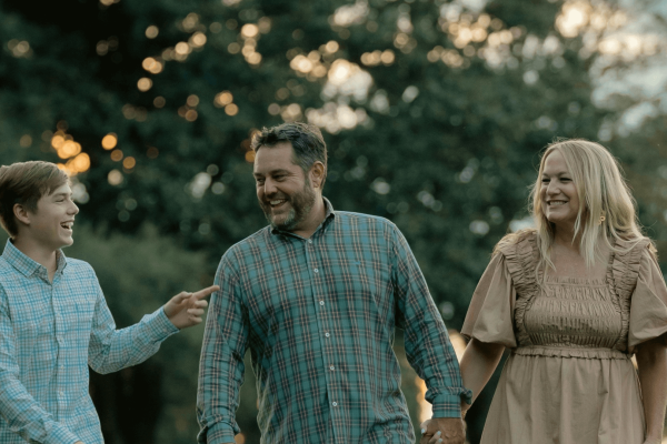 A photo of a couple with their son laughing